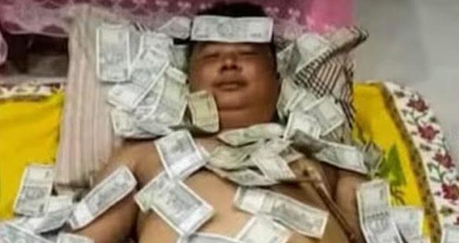 man sleeps in currency