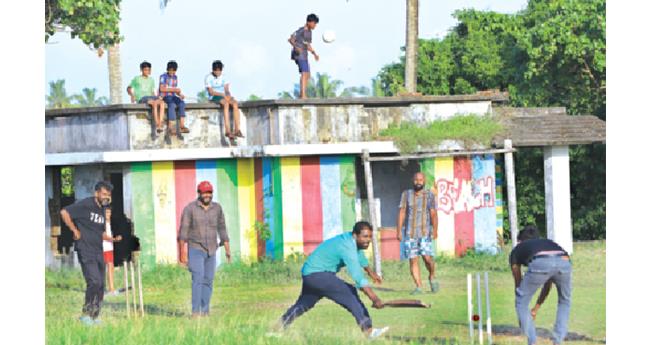 കു​ഴു​പ്പി​ള്ളി ബീ​ച്ചി​നു സ​മീ​പ​ത്തെ ആ​ളൊ​ഴി​ഞ്ഞ പ​റ​മ്പി​ല്‍ ക്രി​ക്ക​റ്റ് ക​ളി​ക്കു​ന്ന യു​വാ​ക്ക​ള്‍.  ക്രി​ക്ക​റ്റ് ക​ളി​ക്ക് ശേ​ഷം ഇ​വി​ടെ ഫു​ട്‌​ബോ​ള്‍ ക​ളി​ക്കാ​നു​ള്ള ത​ങ്ങ​ളു​ടെ അ​വ​സ​ര​ത്തി​നാ​യി കാ​ത്തു​നി​ല്‍​ക്കു​ന്ന കു​ട്ടി​ക​ളാ​ണ് കെ​ട്ടി​ട​ത്തി​ന് മു​ക​ളി​ല്‍.